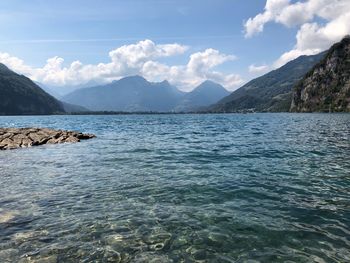 Scenic view of sea and mountains against sky