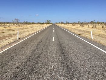 Road passing through landscape against clear sky
