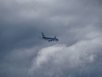 Low angle view of airplane flying in sky