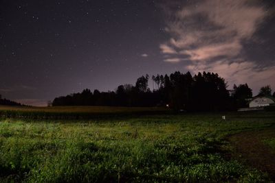 Scenic view of field against sky at night