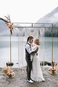 Young couple standing on shore