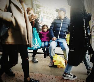 Rear view of people walking in city