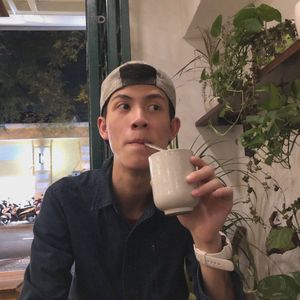 Portrait of man drinking glass in restaurant