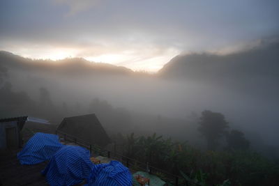 Scenic view of mountains against sky during foggy weather