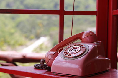 Close-up of telephone booth on table