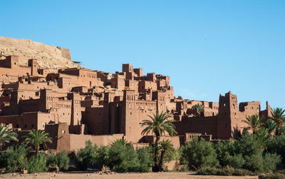 Buildings against clear blue sky