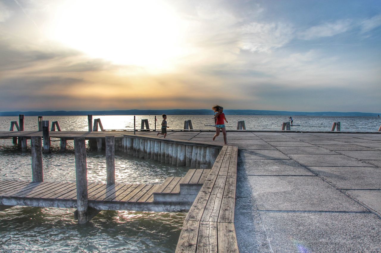 sea, water, sky, horizon over water, pier, cloud - sky, beach, scenics, tranquil scene, sunset, tranquility, beauty in nature, nature, lifestyles, leisure activity, railing, cloud, shore, idyllic