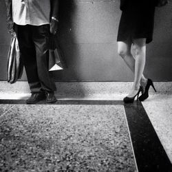 Low section of woman standing on tiled floor