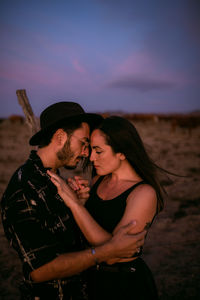 Midsection of couple standing outdoors