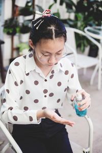 Portrait of a smiling girl holding camera