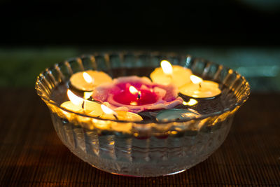 High angle view of lit candles on table