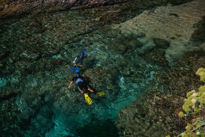 Father and son are diving in the sea. active lifestyle. sport wear. snorkeling  fins and mask