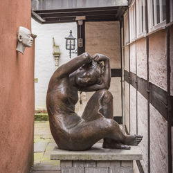 Statue against building in city