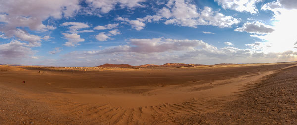 Sand dunes in desert against sky