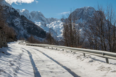 Snow covered landscape against sky