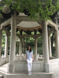 Woman standing against built structure