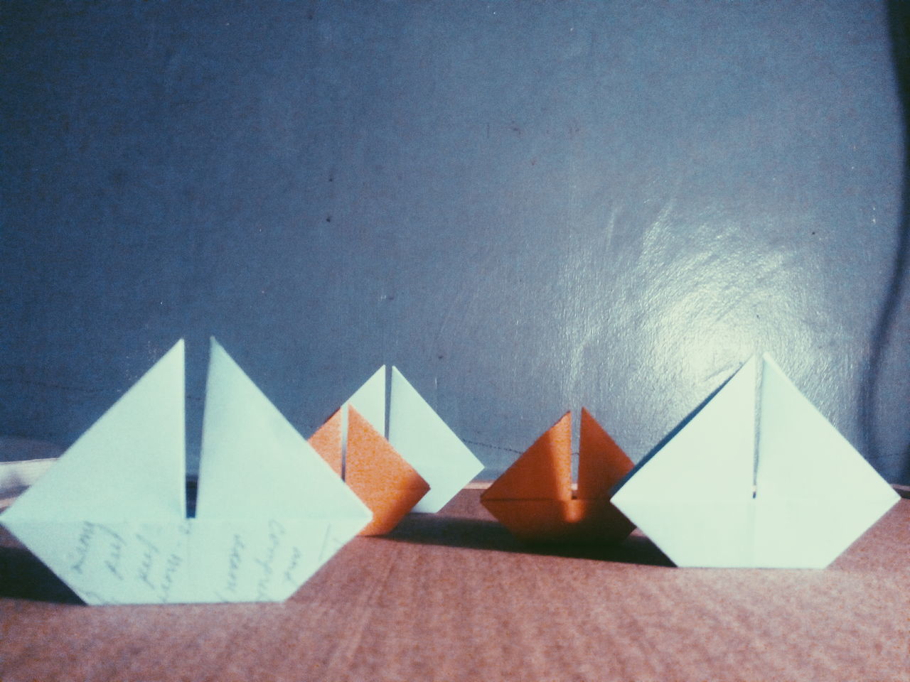 indoors, paper, wall - building feature, copy space, architecture, wall, table, still life, built structure, shadow, white color, creativity, close-up, art and craft, no people, art, white, high angle view, pattern, ideas