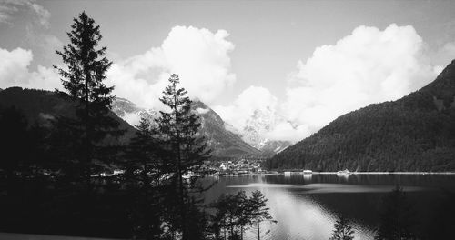 Scenic view of lake by mountains against sky