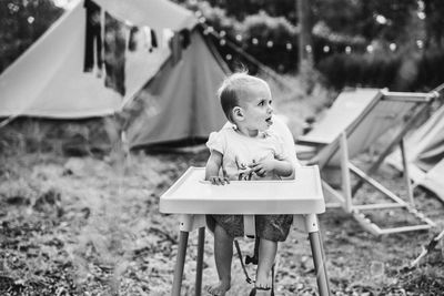 Portrait of young woman sitting on tent