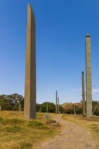 Built structure on field against clear blue sky