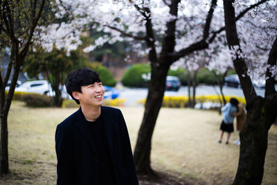 Portrait of smiling young man standing outdoors