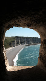 Scenic view of sea seen through arch