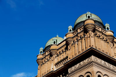 Low angle view of building against blue sky