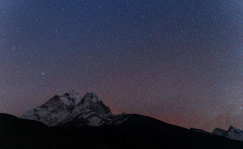 Scenic view of mountains against sky at night