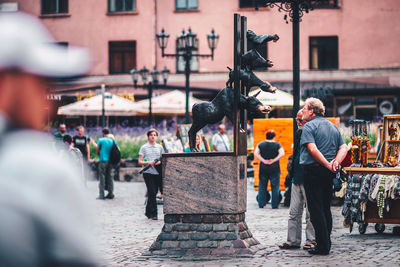 Statue of people in front of building