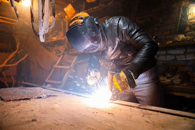 Low section of man working at workshop