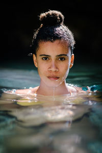 Portrait of young woman in sea