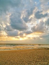 Scenic view of beach against sky during sunset