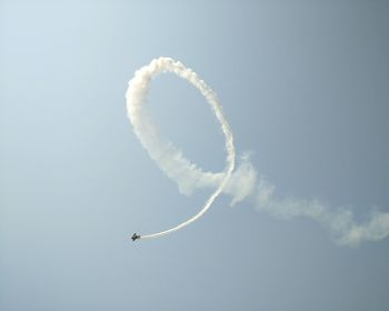 Low angle view of airshow in clear sky