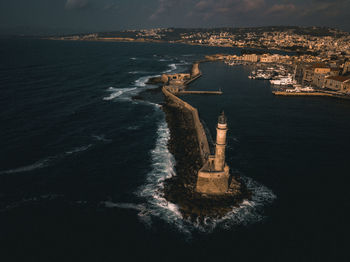 Aerial view of buildings and sea against sky