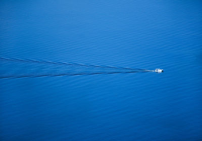 Sailboat on sea against blue sky