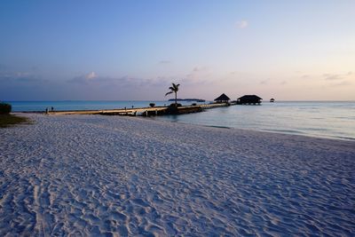 Scenic view of beach against sky during sunset