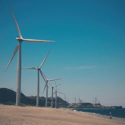 Traditional windmill against clear blue sky