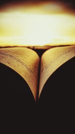 Close-up of open book against black background