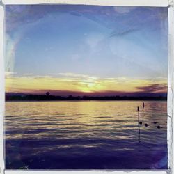 Scenic view of sea against sky at sunset