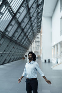 Full length of young man standing in city