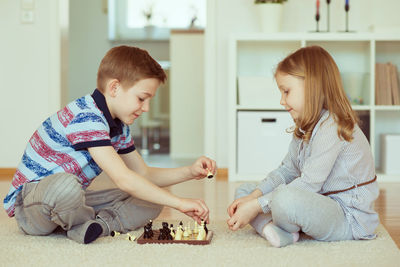 Siblings playing in corridor