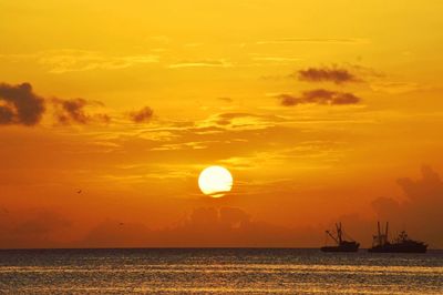 Scenic view of sea against orange sky