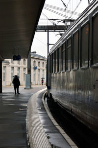 People on railroad station by train