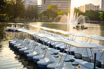 Pedal boats moored on lake