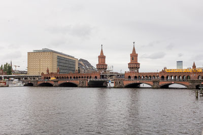 Bridge over river with buildings in background