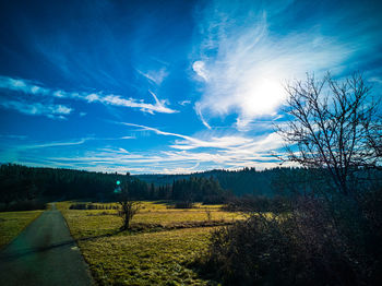 Scenic view of landscape against blue sky