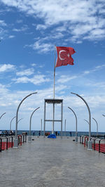 Flag on beach against sky