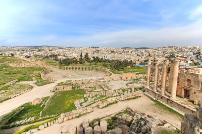 Old ruins in city against sky