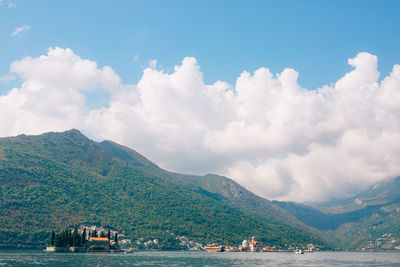 Scenic view of sea and mountains against sky