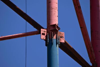 Low angle view of metal pole against clear blue sky